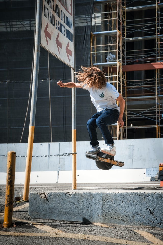 Guy midair with a onewheel