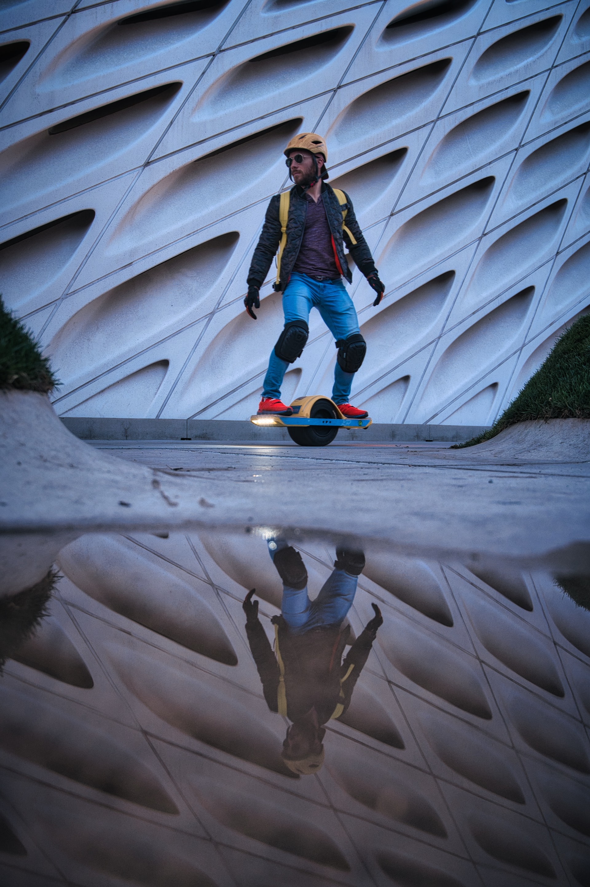 Guy with full safety gear on a onewheel