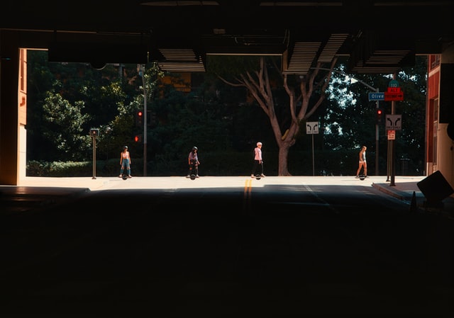 4 girls riding onewheels in a city