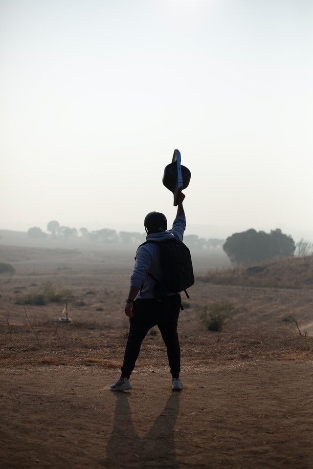 guy holding onewheel above head posing